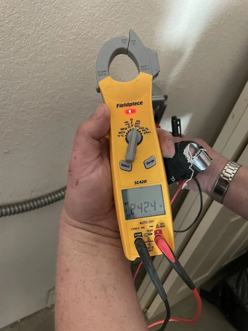 Voltage testing with clamp meter during Ceiling Fan Installation in Madison